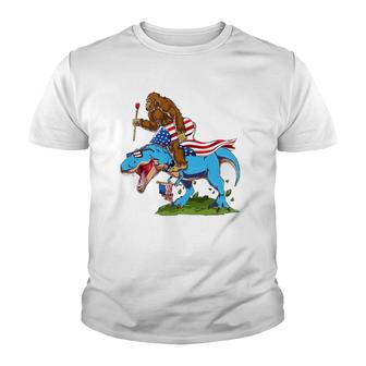 Bigfoot Riding Dinosaur Usa Flag 4Th Of July America Youth T-shirt | Mazezy