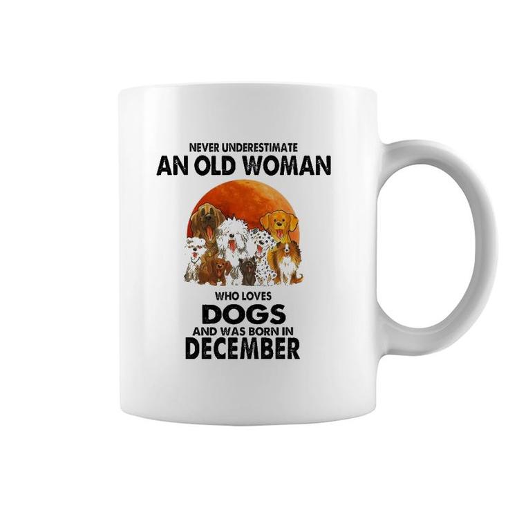 Never Underestimate An Old Woman Who Loves Dogs December Coffee Mug